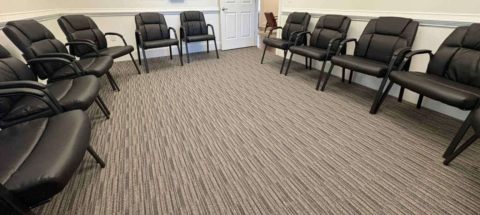 Group room at The Community in Alpharetta with a whiteboard and a circle of chairs